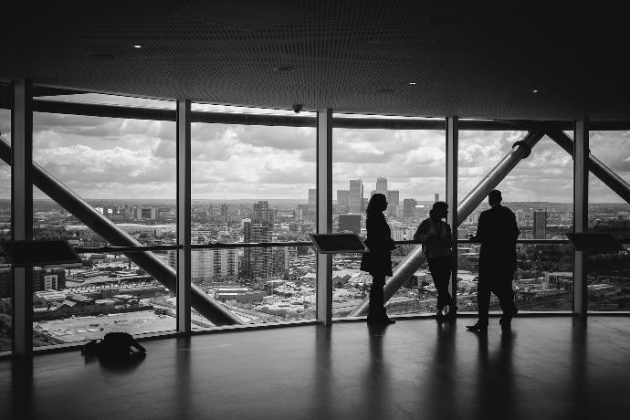 Senior executives standing inside office having casual discussion