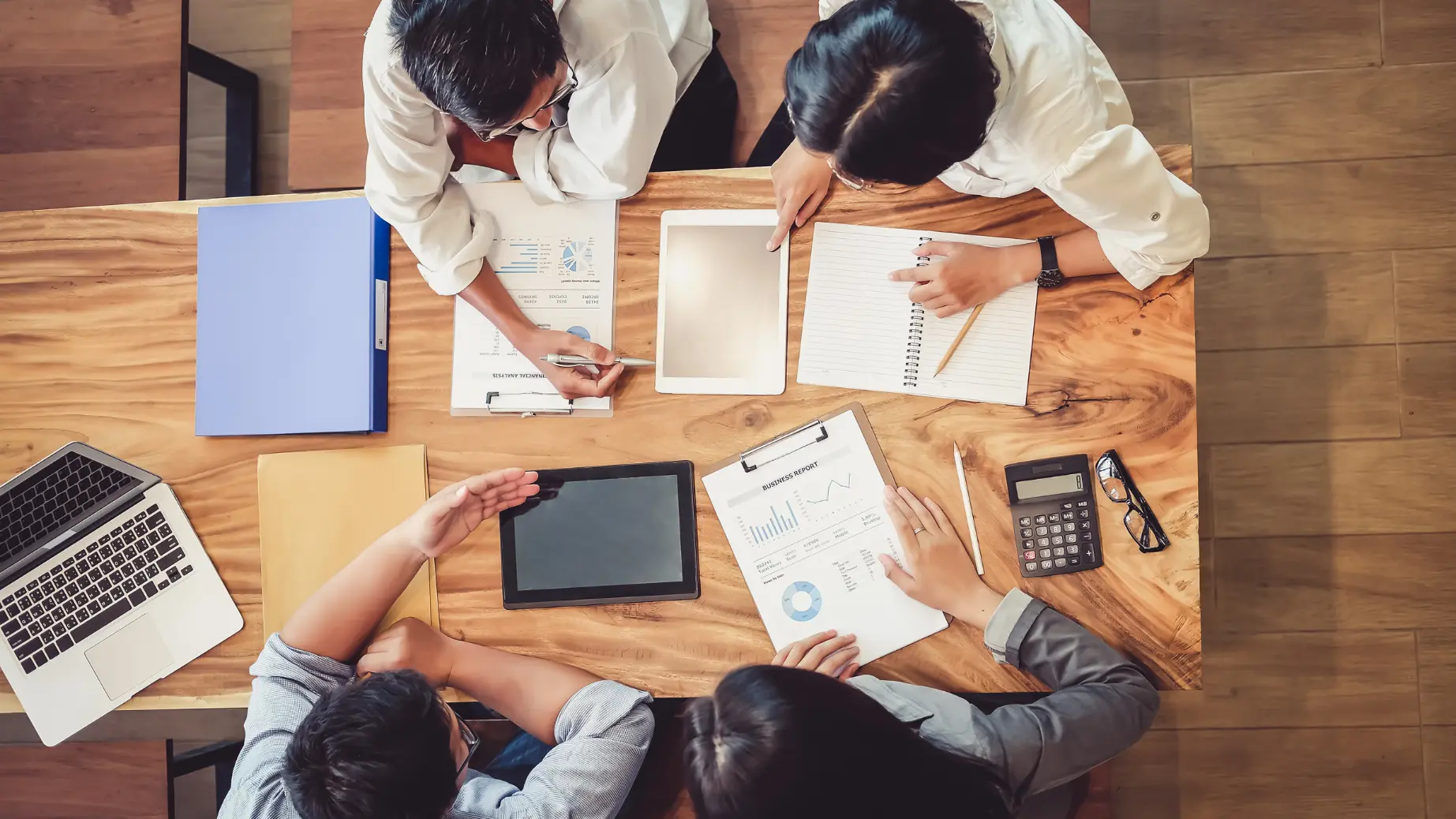 Business analysts and auditors discussing business process improvements and audit ideas in a meeting